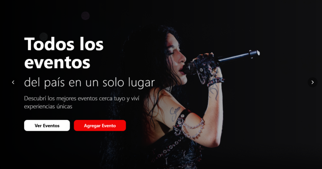 YSY A en un concierto con el micrófono en la mano y las luces del escenario de fondo